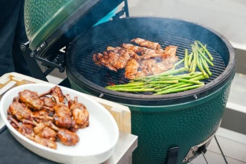 Big Green Egg® grill cooking meat and vegetables from High Elevation Hot Tubs